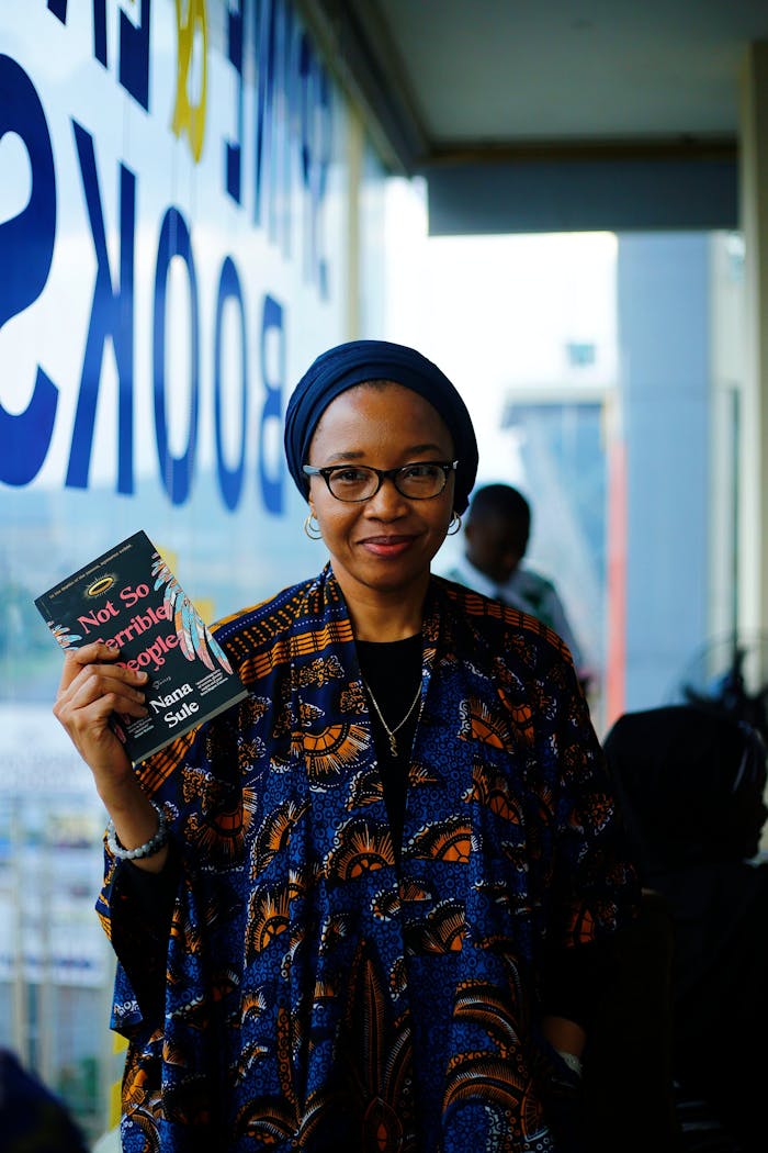 gallery-2 Woman in bookstore holding book with text 'Not So Terrible People' by Name